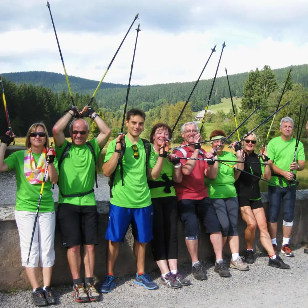 Acht Personen mit Nordic Walking Stöcken bei einer Wanderung im Schwarzwald